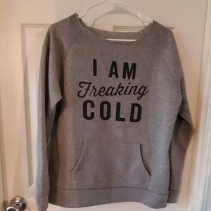 Sweatshirt says "I AM FREAKING COLD" one size